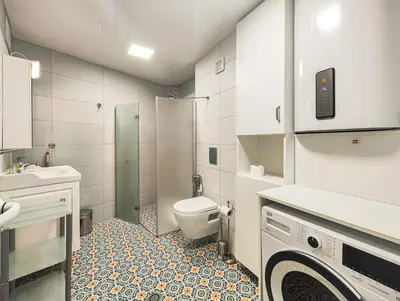 a small bathroom with a toilet and a sink at The Puzzle in Varna City