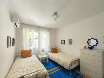 a bedroom with two beds and a dresser in it at The Puzzle in Varna City