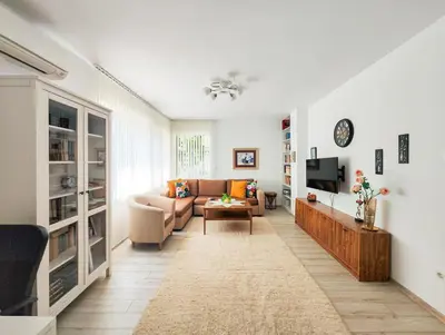 a living room with a couch and a tv at The Puzzle in Varna City