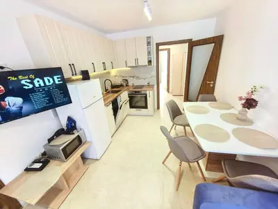 a small kitchen with a table and chairs in a room at Sunny Dream Family Apartment in Sunny Beach