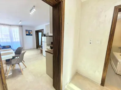 a kitchen and a living room with a table at Sunny Dream Family Apartment in Sunny Beach
