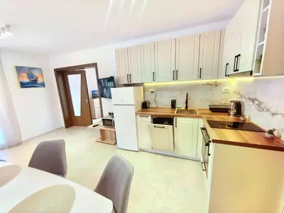 a kitchen with white cabinets and a white refrigerator at Sunny Dream Family Apartment in Sunny Beach