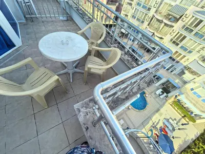 a balcony with a table and chairs on a building at Sunny Dream Family Apartment in Sunny Beach