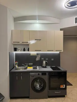 a kitchen with a washing machine and a sink at YS Platinum Residence in Sunny Beach