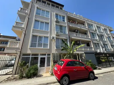 a red car parked in front of a building at Sunny Day 7 in Burgas City