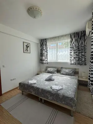 a bedroom with a bed and a window at Sunny Day 7 in Burgas City