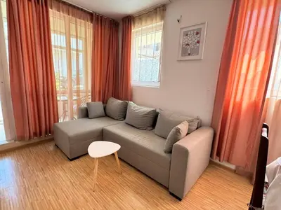 a living room with a couch and a table at Sunny Day 7 in Burgas City