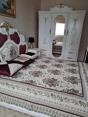 a bedroom with a large white bed with a mirror at Апартамент в КК 