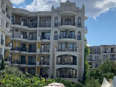 a tall white building with balconies on it at Schöne Ferienwohnung im Harmony Suites Monte Carlo in Sunny Beach