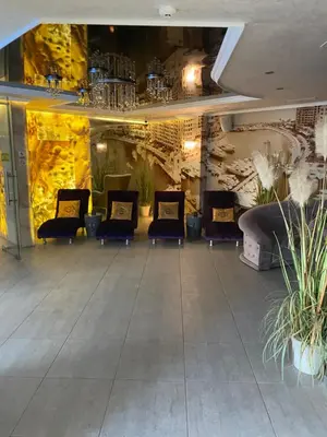a waiting area with chairs and plants in a lobby at Schöne Ferienwohnung im Harmony Suites Monte Carlo in Sunny Beach