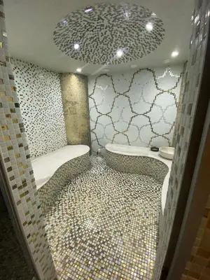 a bathroom with a shower with a tiled floor at Schöne Ferienwohnung im Harmony Suites Monte Carlo in Sunny Beach