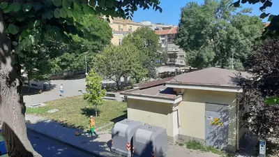 a building with two parking meters next to a street at Mila 6 in Burgas City