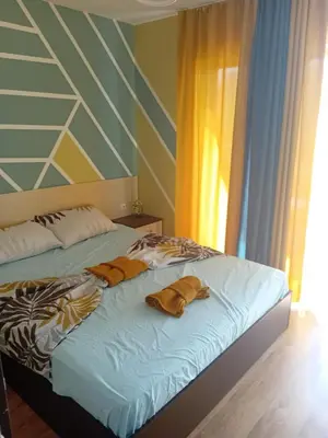 a bed with two towels on it in a room at Тристаен апартамент Еуфория, Свети Влас in Sveti Vlas