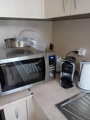 a kitchen counter with a microwave and a blender at Тристаен апартамент Еуфория, Свети Влас in Sveti Vlas
