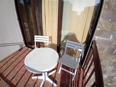 two chairs and a table on a balcony at Тристаен апартамент Еуфория, Свети Влас in Sveti Vlas