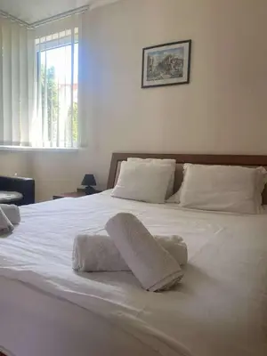 a large white bed with two towels on it at Ground Floor, 2-Bed Apartment in Sunny Beach