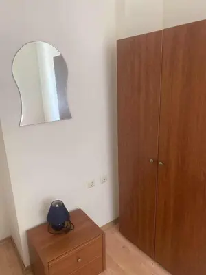 a room with a mirror and a wooden cabinet at Ground Floor, 2-Bed Apartment in Sunny Beach