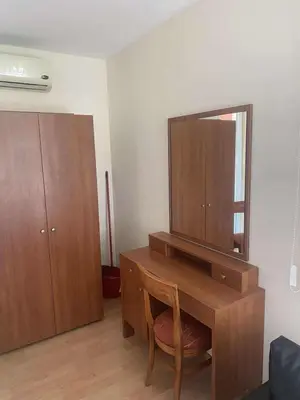 a desk with a mirror and a cabinet in a room at Ground Floor, 2-Bed Apartment in Sunny Beach