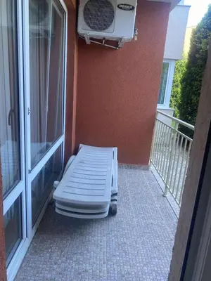 a mattress sitting on a porch next to a balcony at Ground Floor, 2-Bed Apartment in Sunny Beach