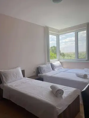 two beds in a room with two windows at Family, Friendly 2 Bed Apartment in Sunny Beach