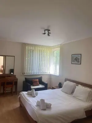 a bedroom with a large white bed and a chair at Family, Friendly 2 Bed Apartment in Sunny Beach