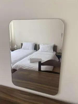a mirror reflection of two beds in a bedroom at Family, Friendly 2 Bed Apartment in Sunny Beach