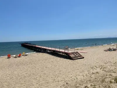 a pier on a beach with people on the beach at ANDALUSIA BEACH A602 Elenite in Burgas City