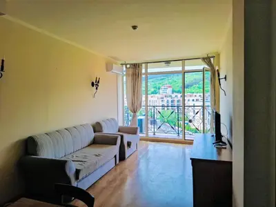 a living room with a couch and a large window at ANDALUSIA BEACH A602 Elenite in Burgas City