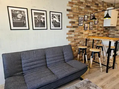 a living room with a couch and a table at Comfy Flat Sea View & Strong Wi-Fi in Varna City