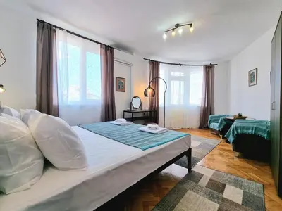a bedroom with a large bed in a room at Central - 3BD Holiday Apartment for Family & Friends in Burgas City