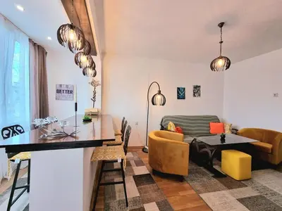 a living room with a table and a couch at Central - 3BD Holiday Apartment for Family & Friends in Burgas City
