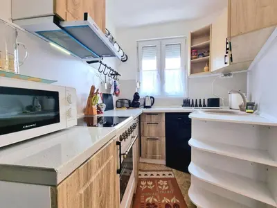a kitchen with white counters and a microwave at Central - 3BD Holiday Apartment for Family & Friends in Burgas City