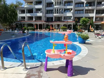 a water slide in front of a swimming pool at Aura Blu Studio in Sunny Beach