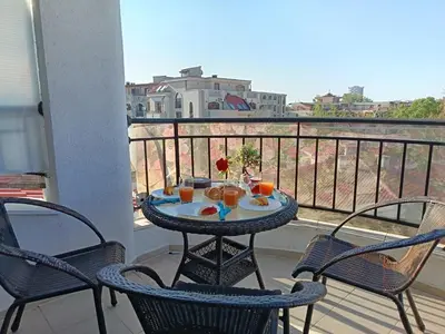 a table and chairs on a balcony with a view at Aura Blu Studio in Sunny Beach