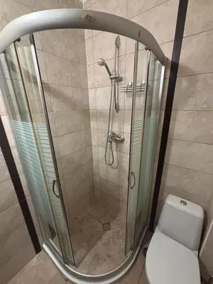 a shower stall in a bathroom with a toilet at Стая за гости - 1 in Sozopol