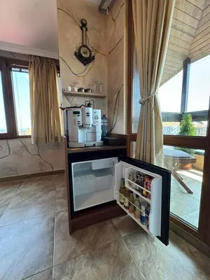 a refrigerator with its door open in a kitchen at Стая за гости - 1 in Sozopol