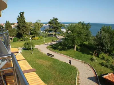 a balcony of a building with a view of a park at Nessebar View Apartament in Nesebar
