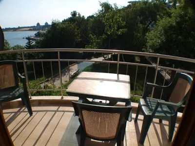 a patio with chairs and a table on a balcony at Nessebar View Apartament in Nesebar