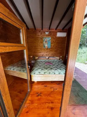 a small room with a bed in a cabin at Вила Бонита плаж Градина in Burgas City