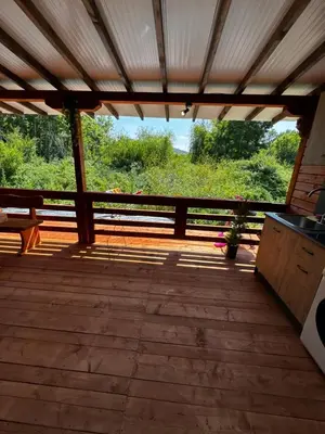 a screened in porch with a view of the forest at Вила Бонита плаж Градина in Burgas City