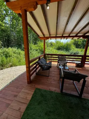 a pavilion with chairs and tables on a wooden deck at Вила Бонита плаж Градина in Burgas City