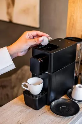 a person is pouring coffee into a coffee maker at KIM Centre in Burgas City