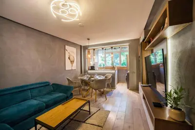 a living room with a blue couch and a table at KIM Centre in Burgas City