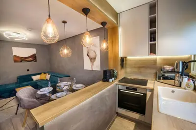 a kitchen with a table and a living room at KIM Centre in Burgas City