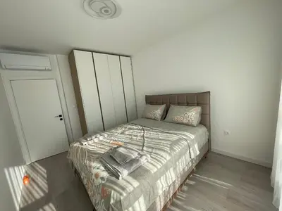 a small bedroom with a bed and a closet at Сарафово in Burgas City