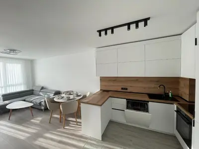 a kitchen and living room with a table and a couch at Сарафово in Burgas City