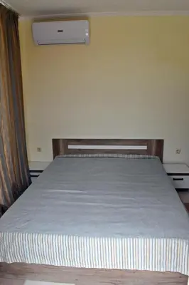 a bed in a room with at Anvers Apartments in Sozopol