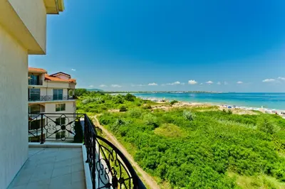 a balcony with a view of the ocean at Anvers Apartments in Sozopol