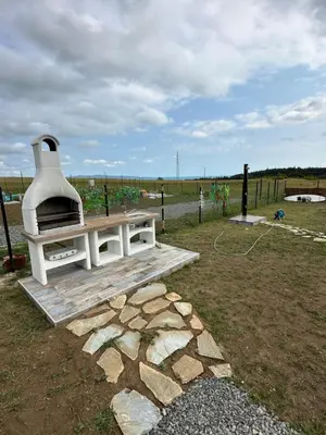 a outdoor pizza oven sitting on top of a field at Морски Бриз in Lozenets