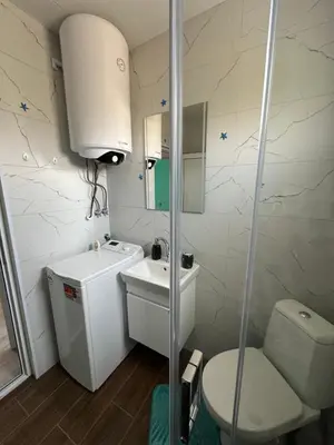 a bathroom with a toilet and a sink and a shower at Морски Бриз in Lozenets